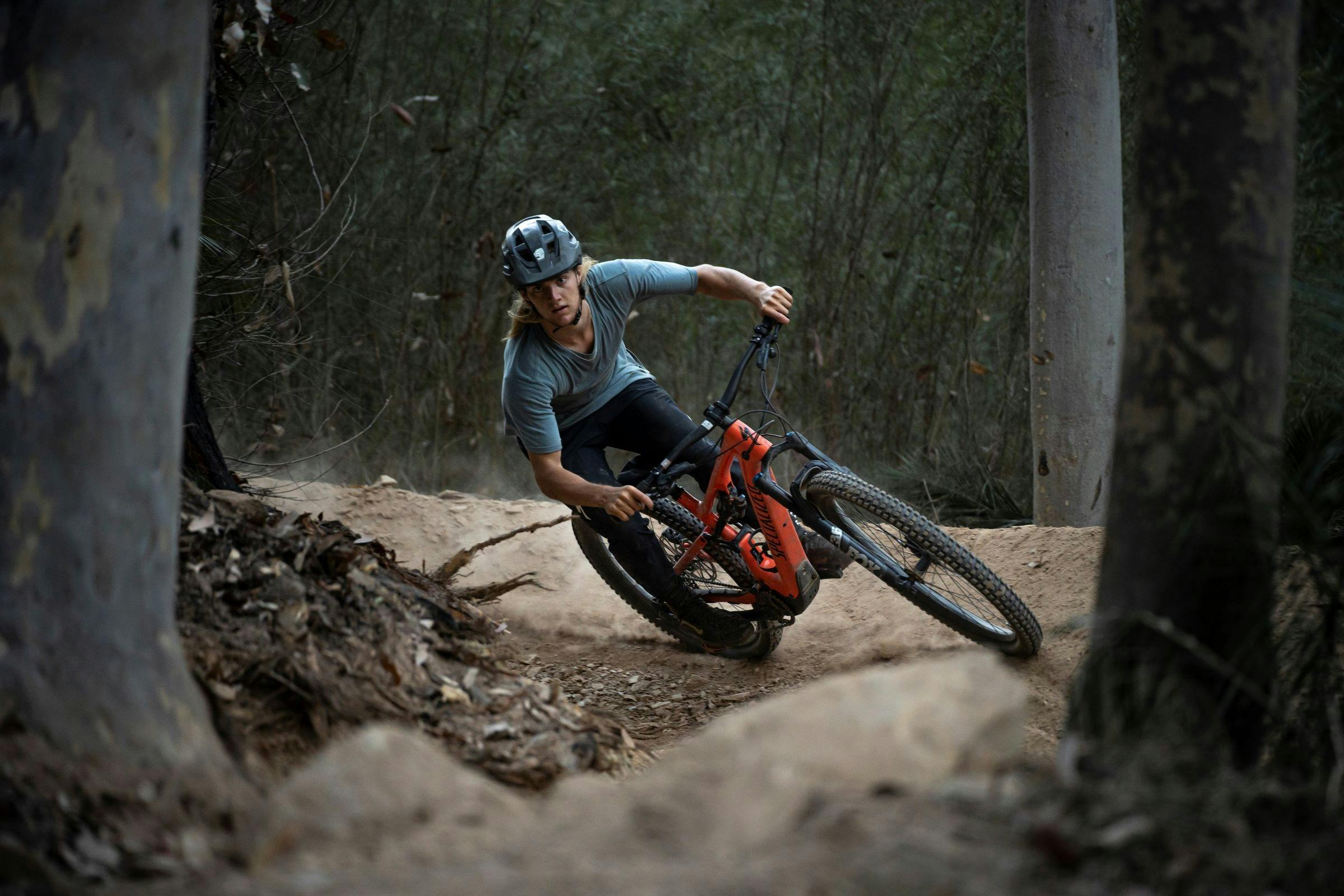 lone mountain biker cornering in berm