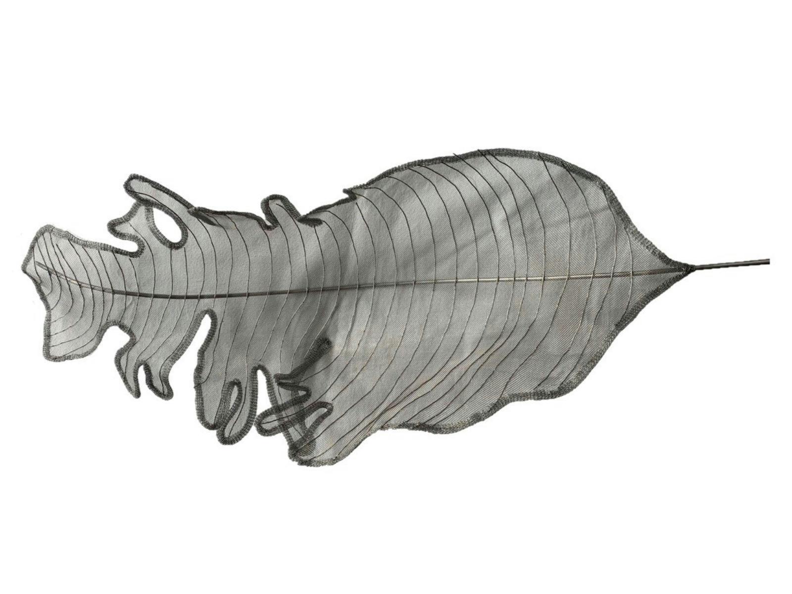 Leaf shaped sculpture that is made out of stainless steel and stone