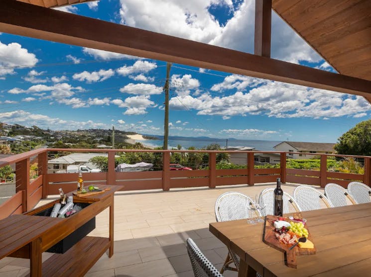 Spacious balcony with ocean views, dining setting
