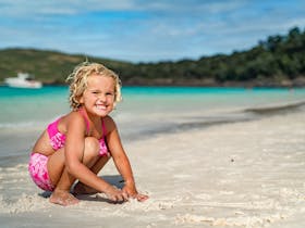 child playing on whitehaven beach