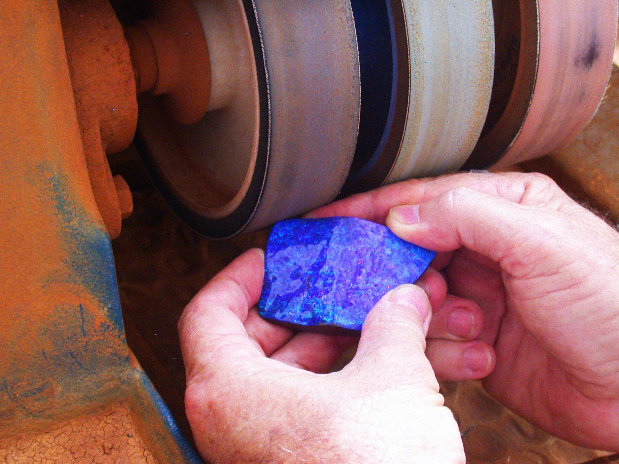 piece of opal being cut and polished piece of opal being cut and polished