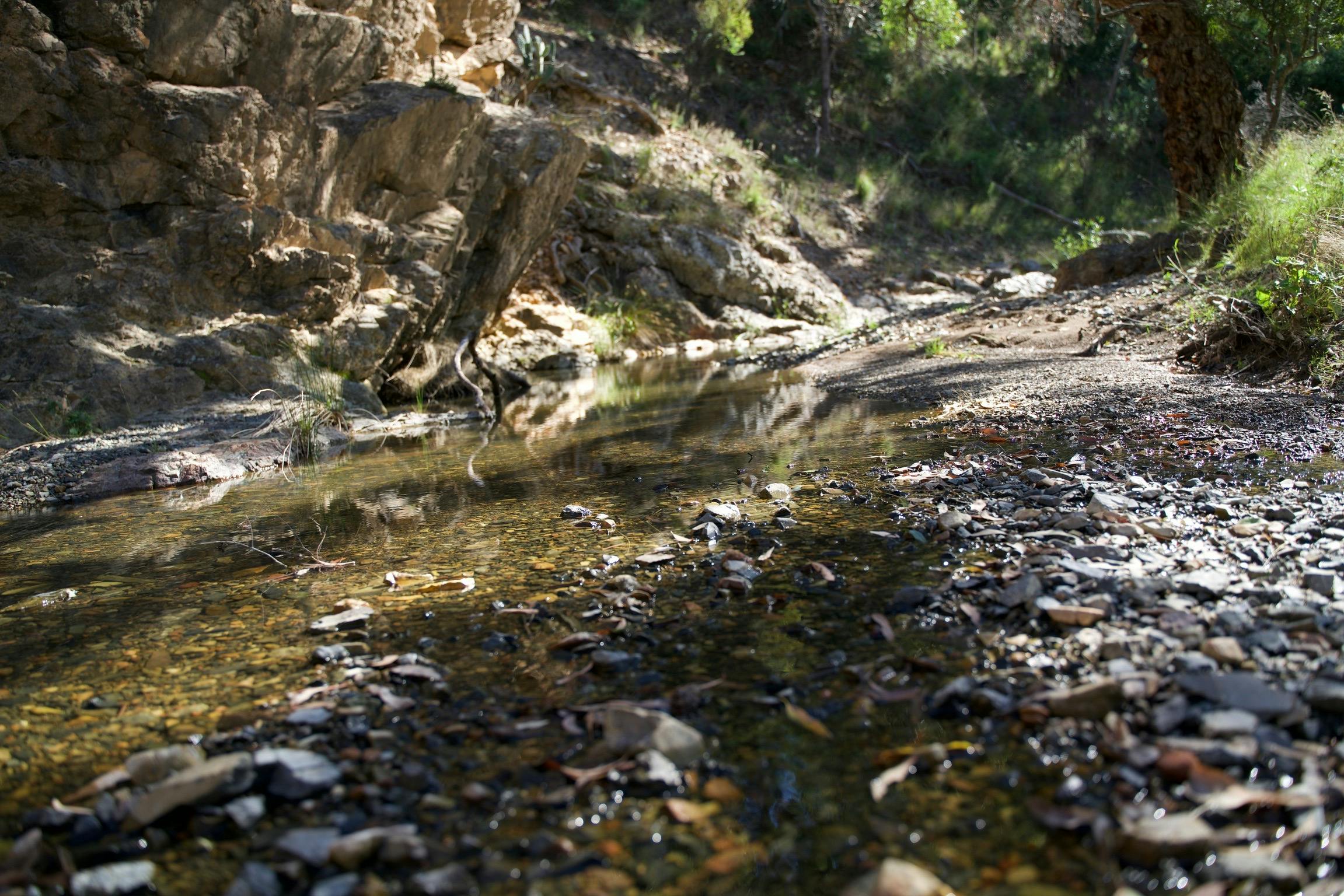 Traverse along rocky granite creek beds at Verona