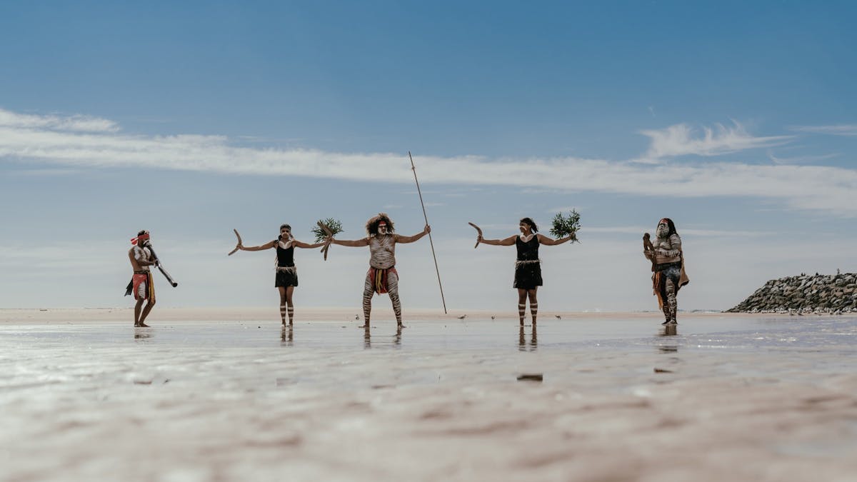 The Yugambeh Aboriginal Dancers perform on the beach during a Jellurgal Walkabout Tour