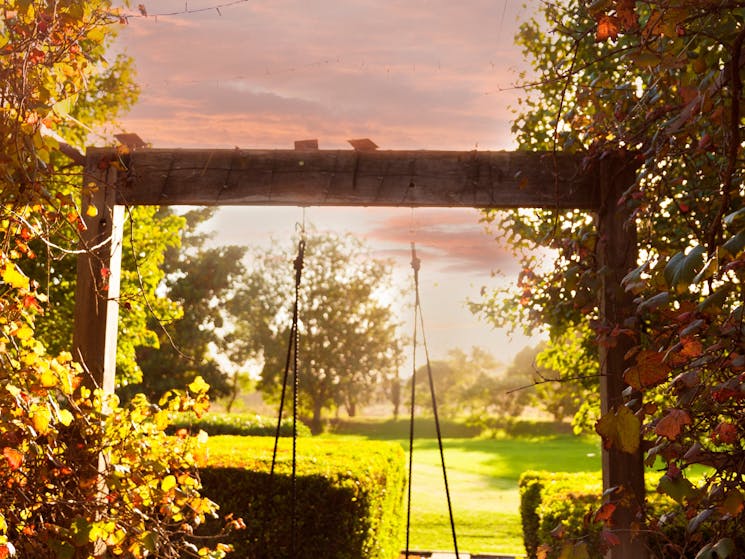 View to the west gardens, vine walkway and swing.  Glorious sunsets from this angle.