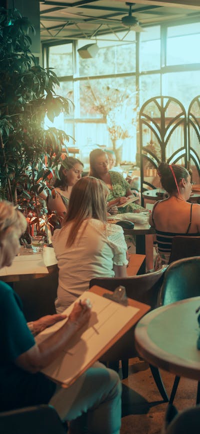 People sitting at tables drawing