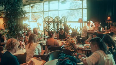 People sitting at tables drawing