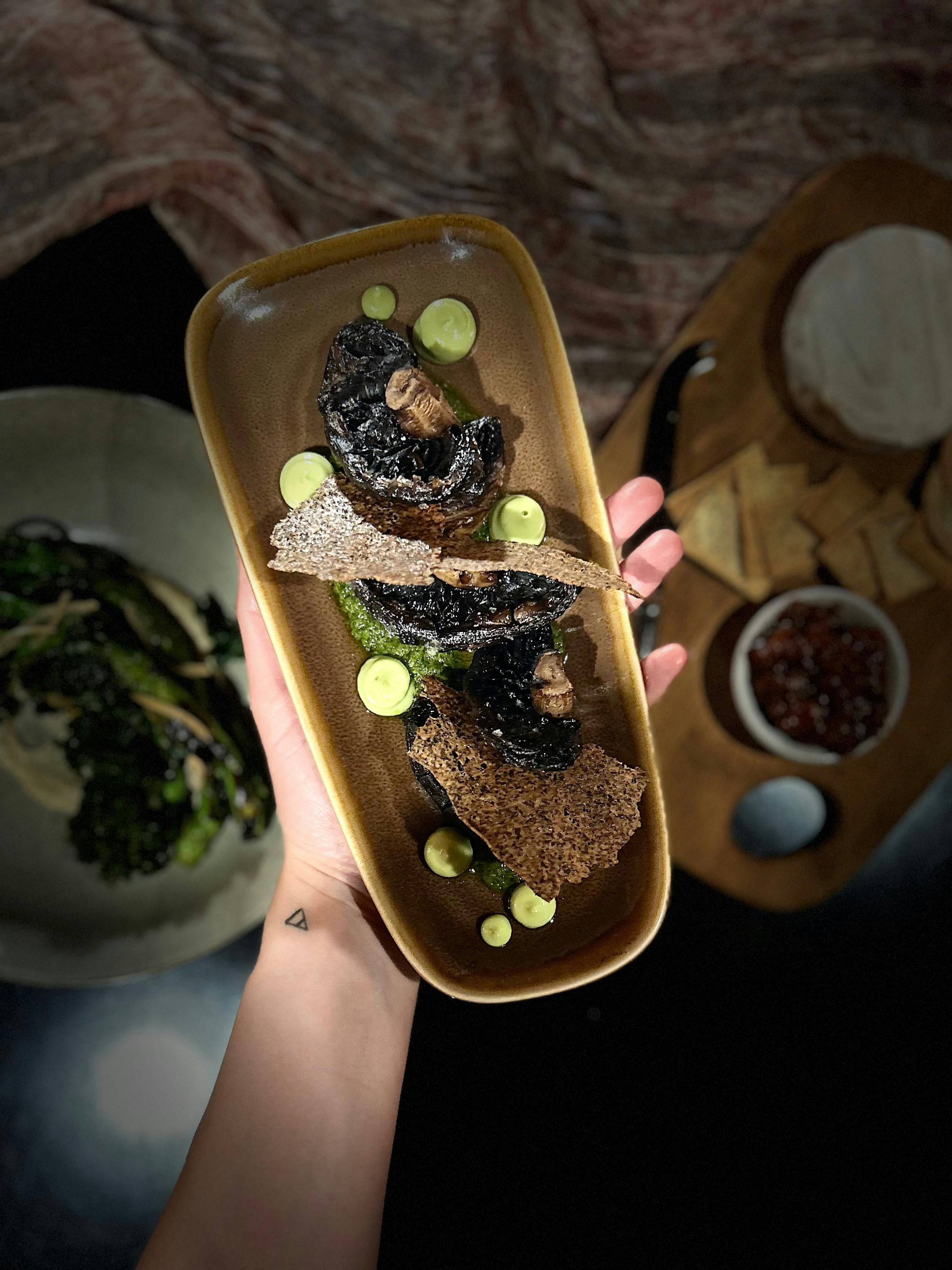Charred mushrooms with avocado and black rice, inspired by Argentinian flavours.