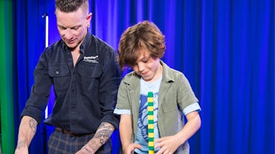 A man and a boy explore patterns using coloured blocks
