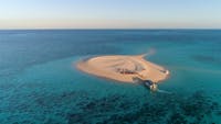 Sip sundowners and feel the sand beneath your feet on isolated sand cays and uninhabited islands