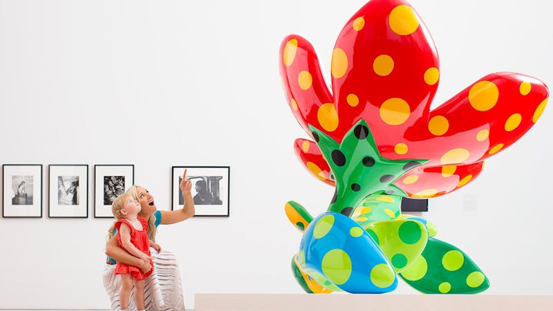 Visitors with Yayoi Kusama's 'Flowers that bloom at midnight' 2012 / GOMA2