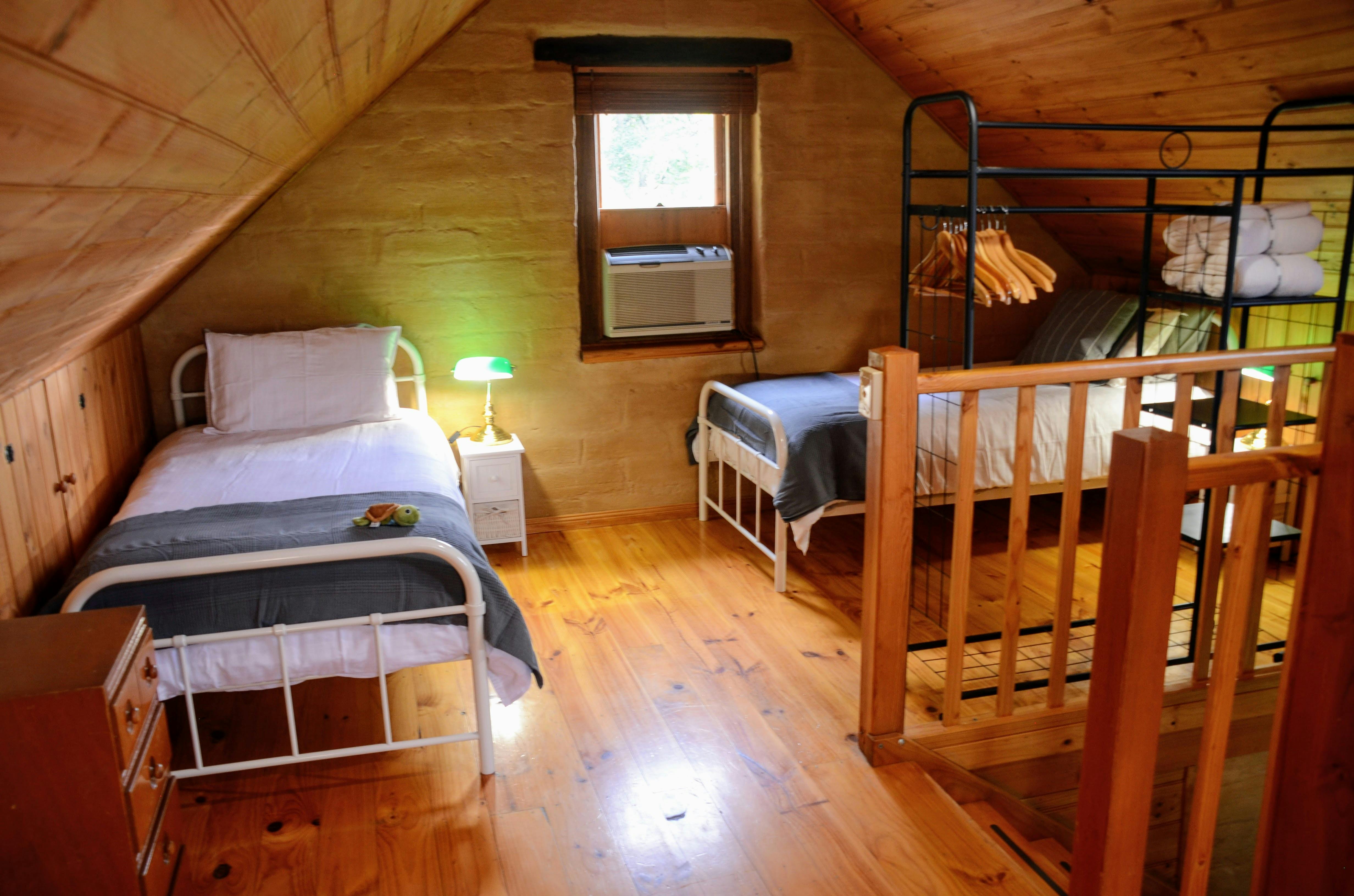 Two single beds in an upstairs sleeping area