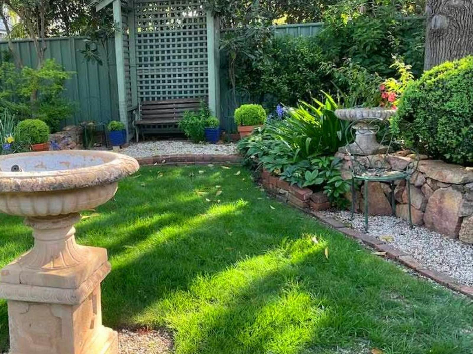 grassed area with bird bath