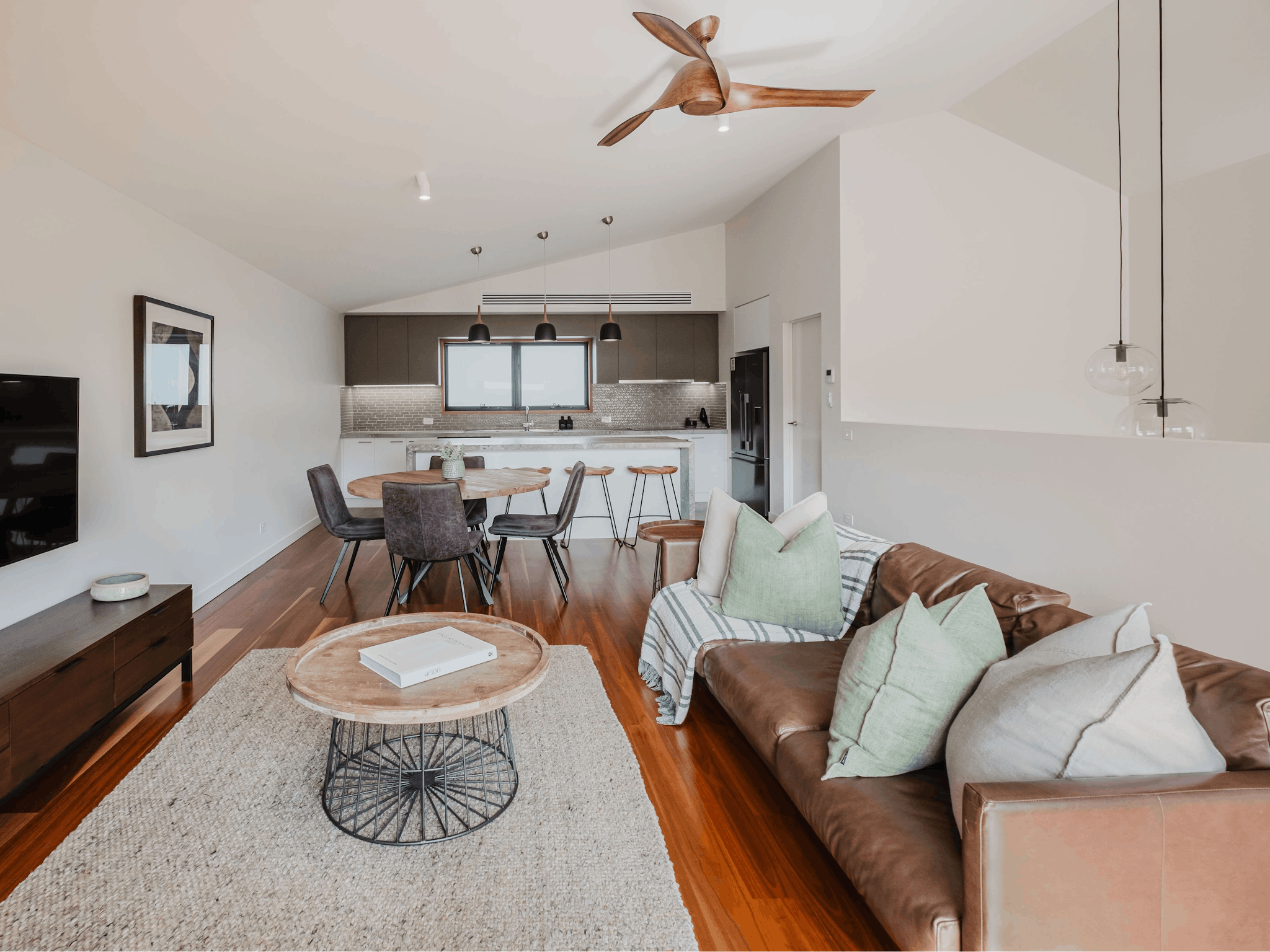 living area with couch, television, dining table