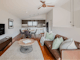 living area with couch, television, dining table