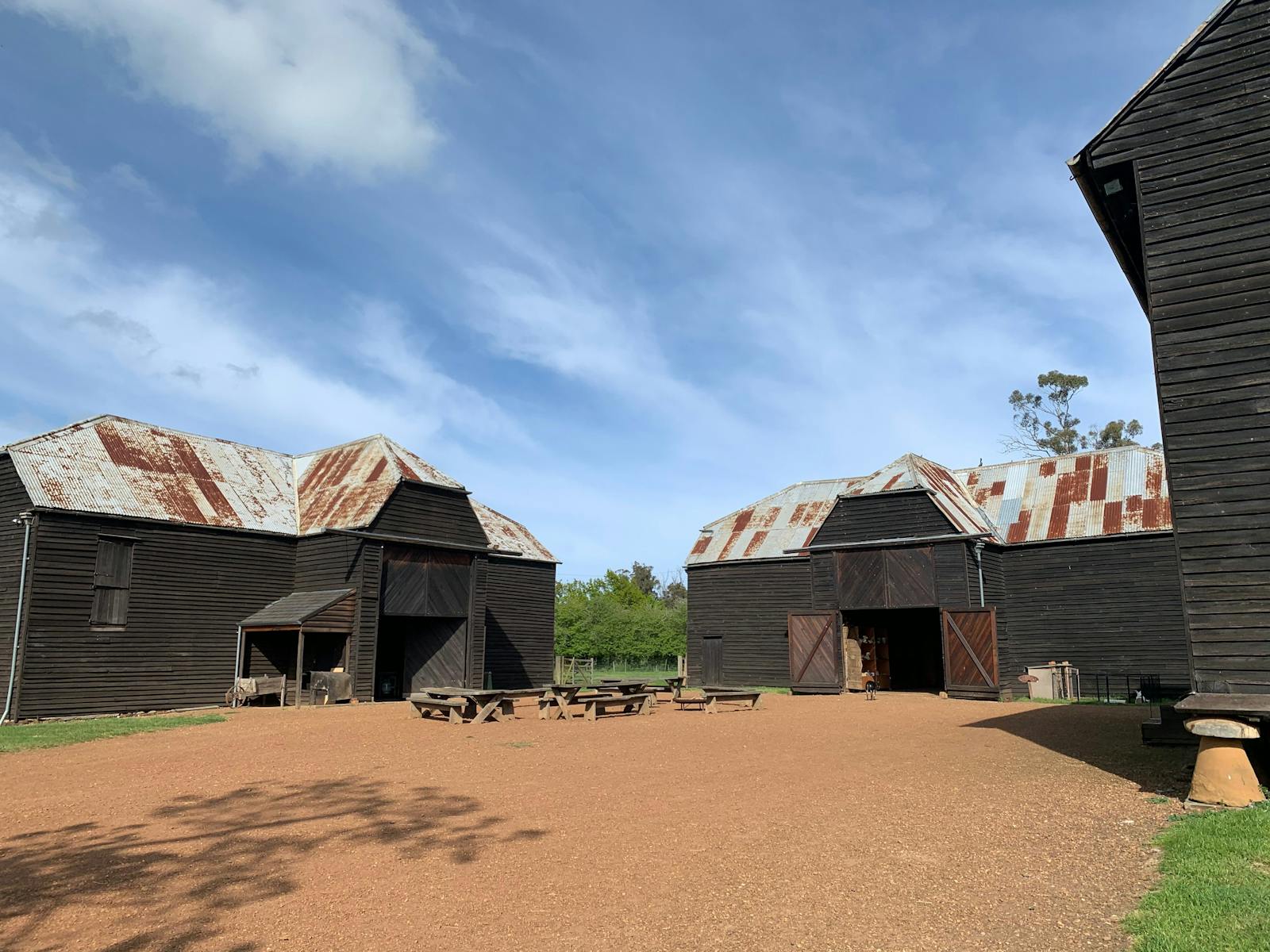 Three large barns surrounding quadrangle of farm village