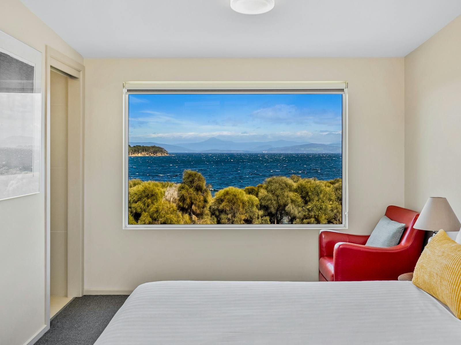 Master bedroom with queen-size bed and reading chair