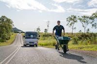 A man participates in the Great Wheelbarrow Race from Mareeba to Chillagoe, Tropical North QLD.