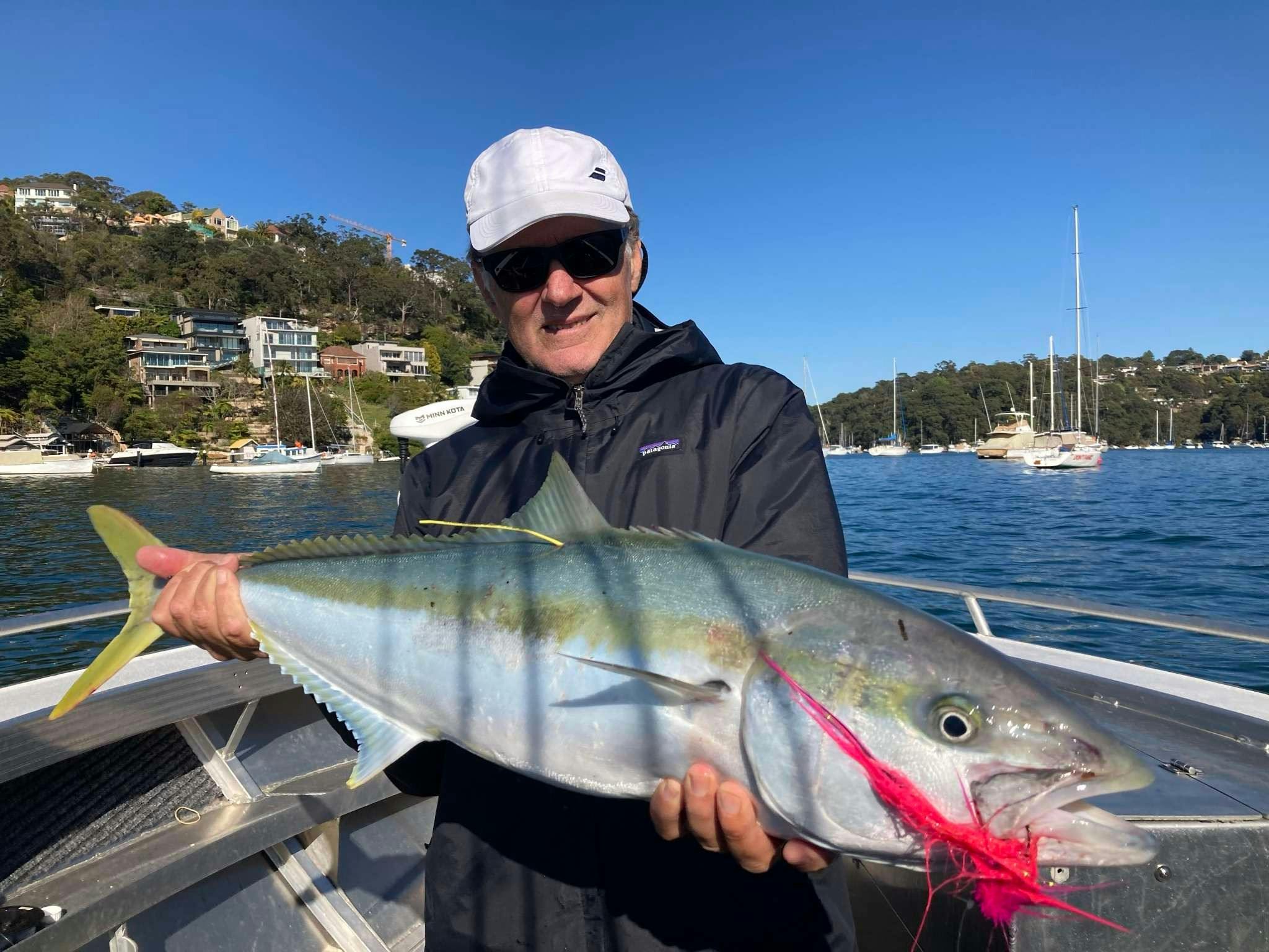 Angler holding a caught fish on the boat