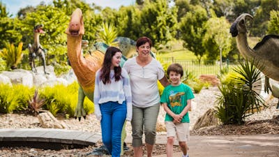 Teenage girl, Auntie and little boy strolling in the Dinosaur Garden