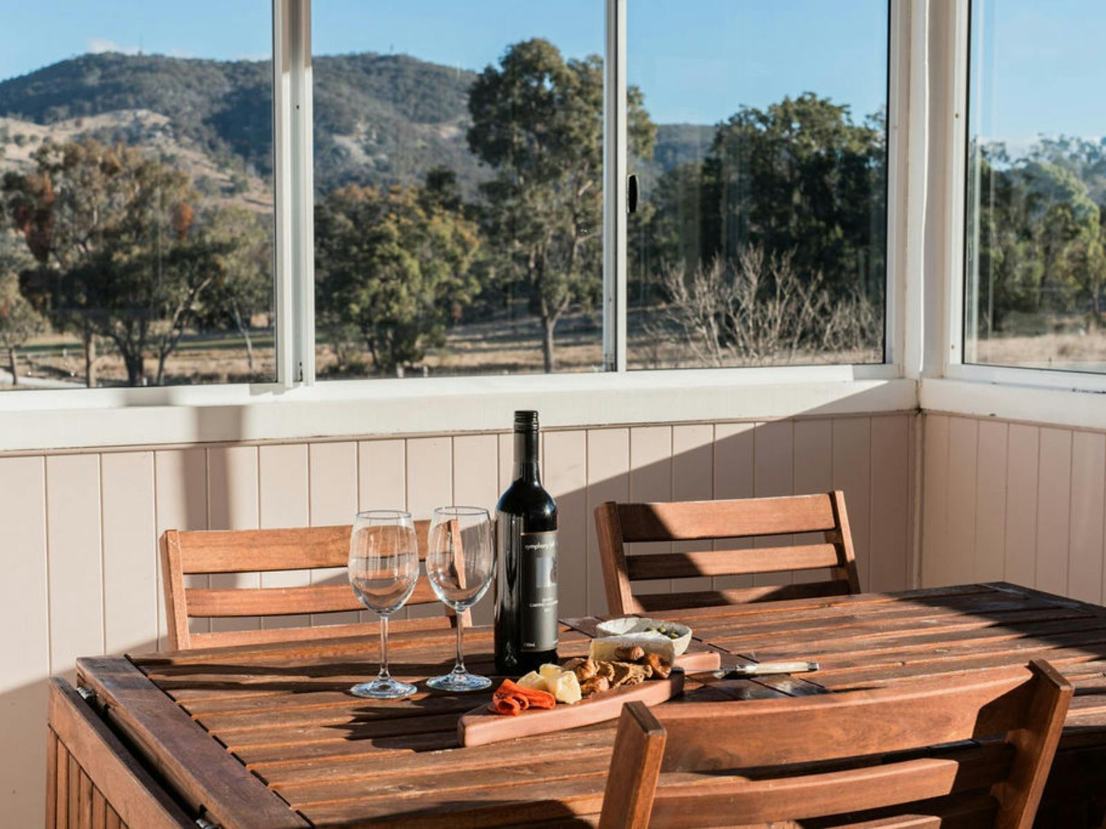 Wine and cheeseboard on outdoor table