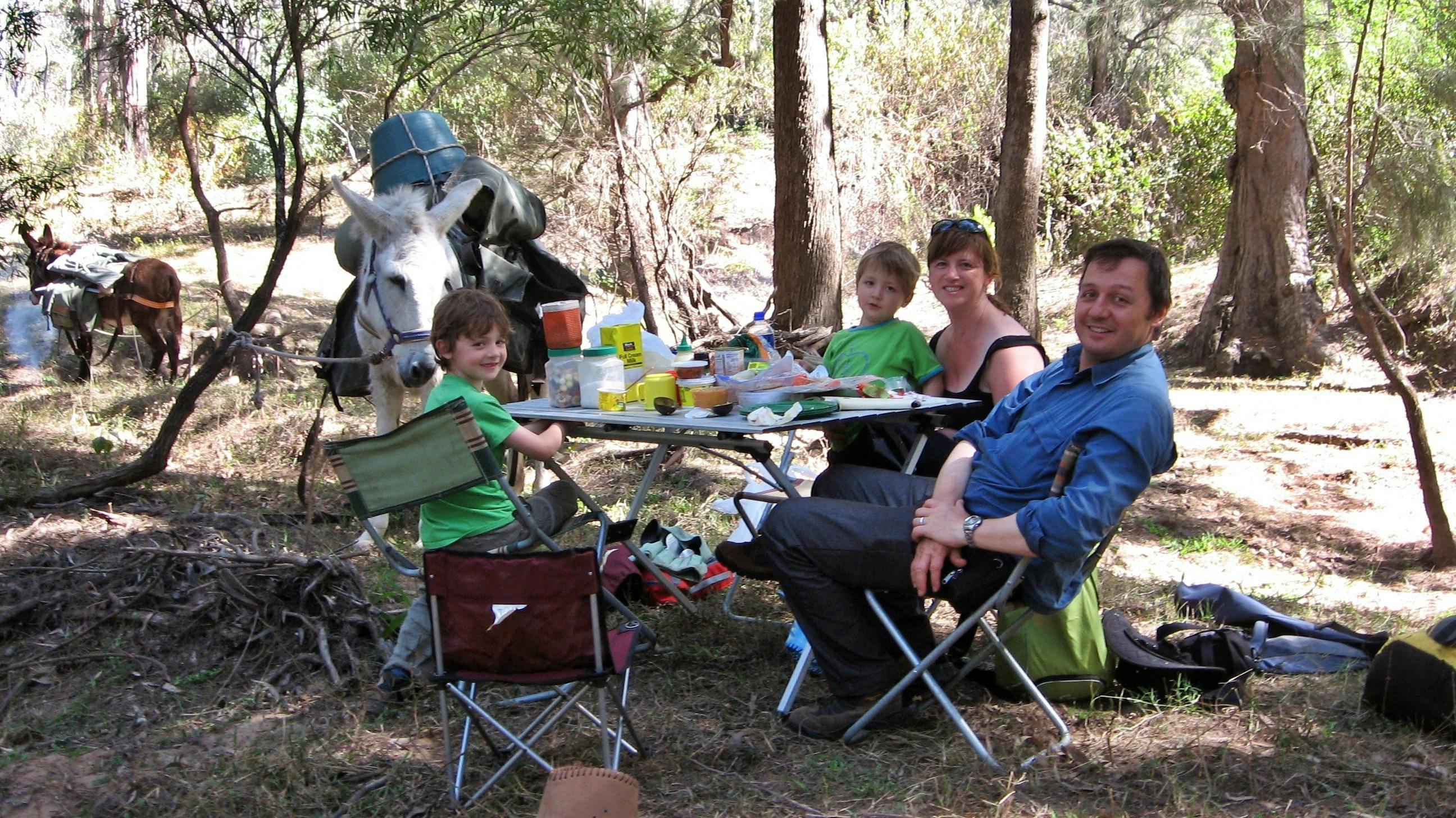 A family enjoying a picnic lunch on the Wild River during a Wild River Pack Donkey trek