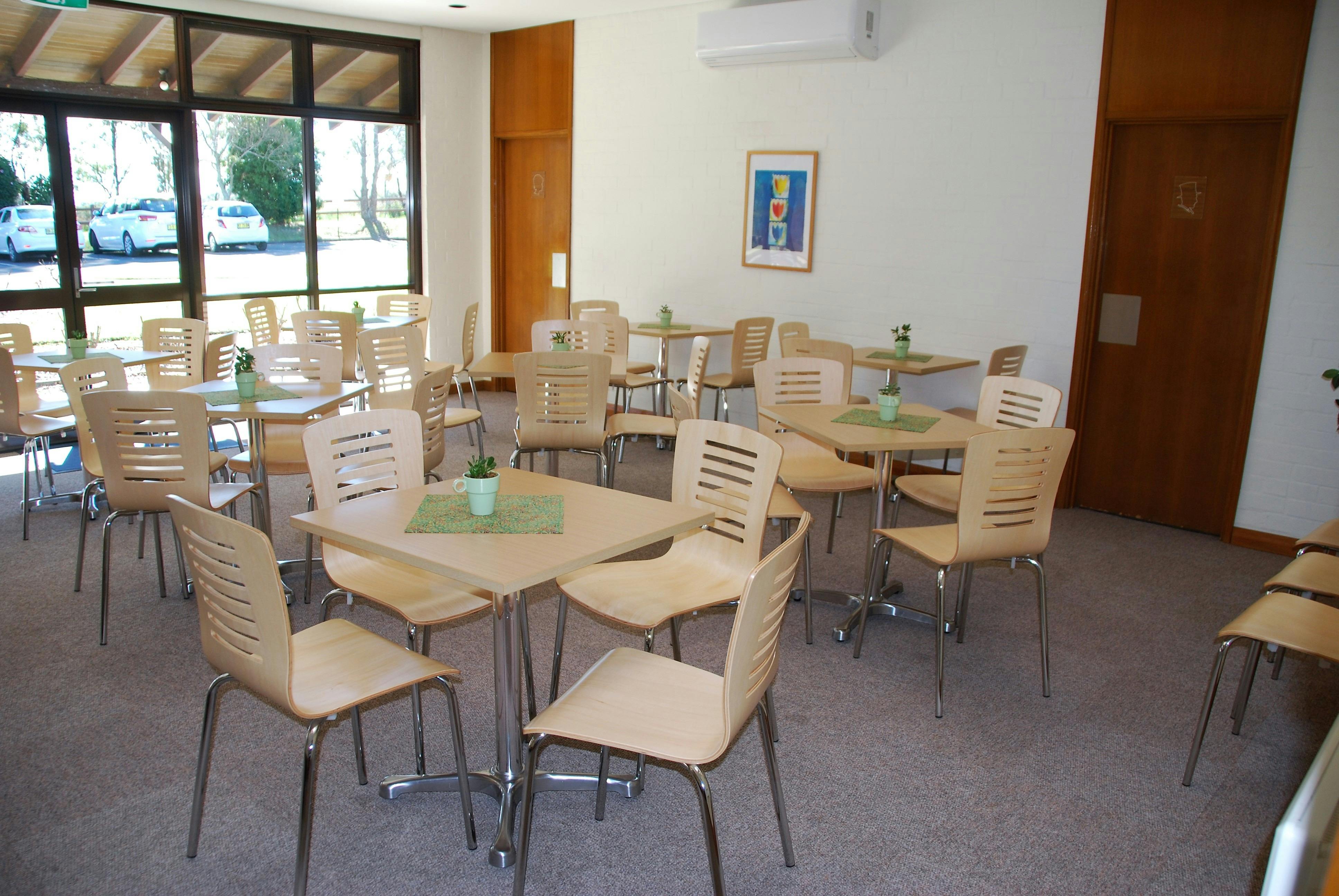 JKH Sunroom with square tables and chairs