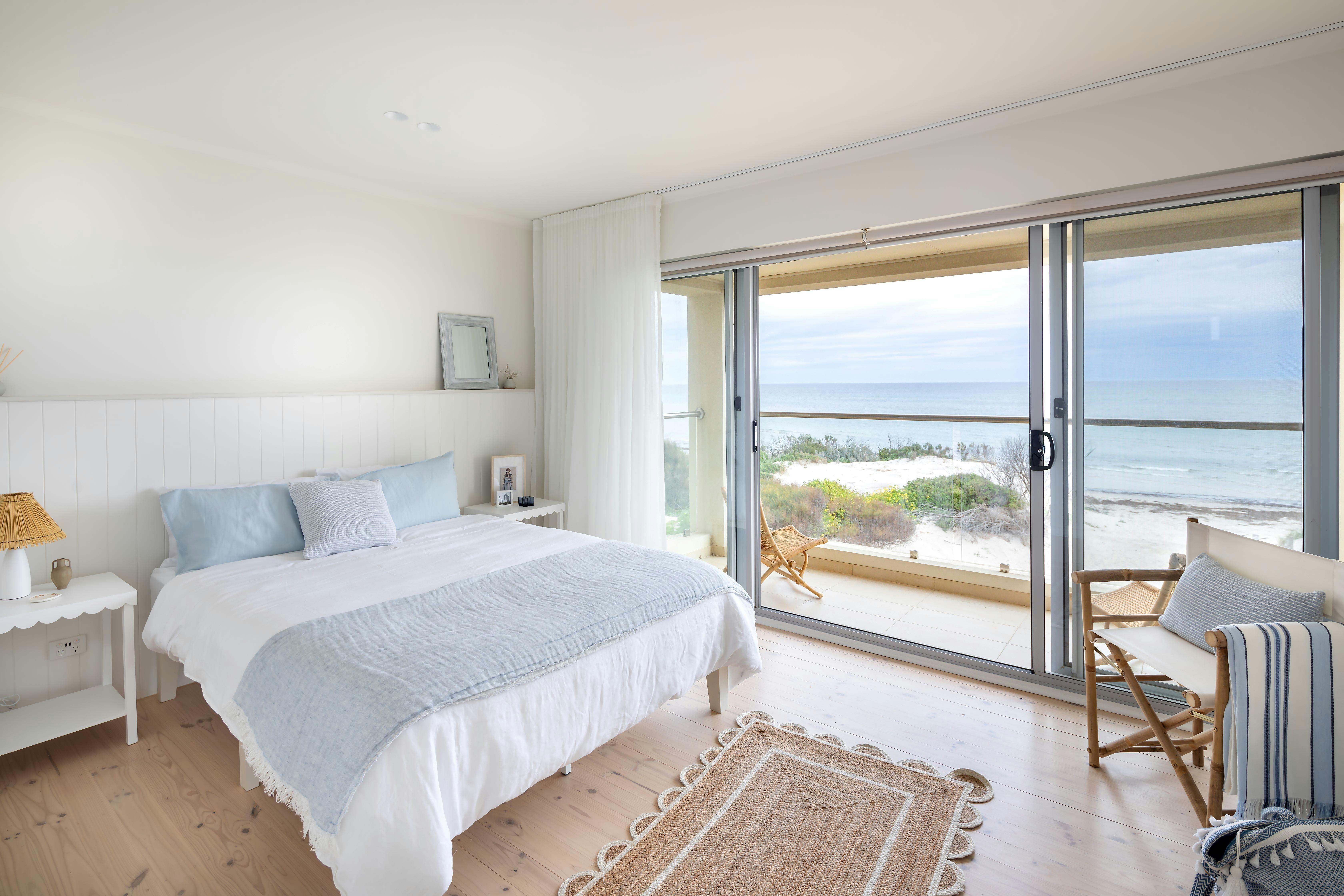 Master bedroom with a queen bed and panoramic sea view