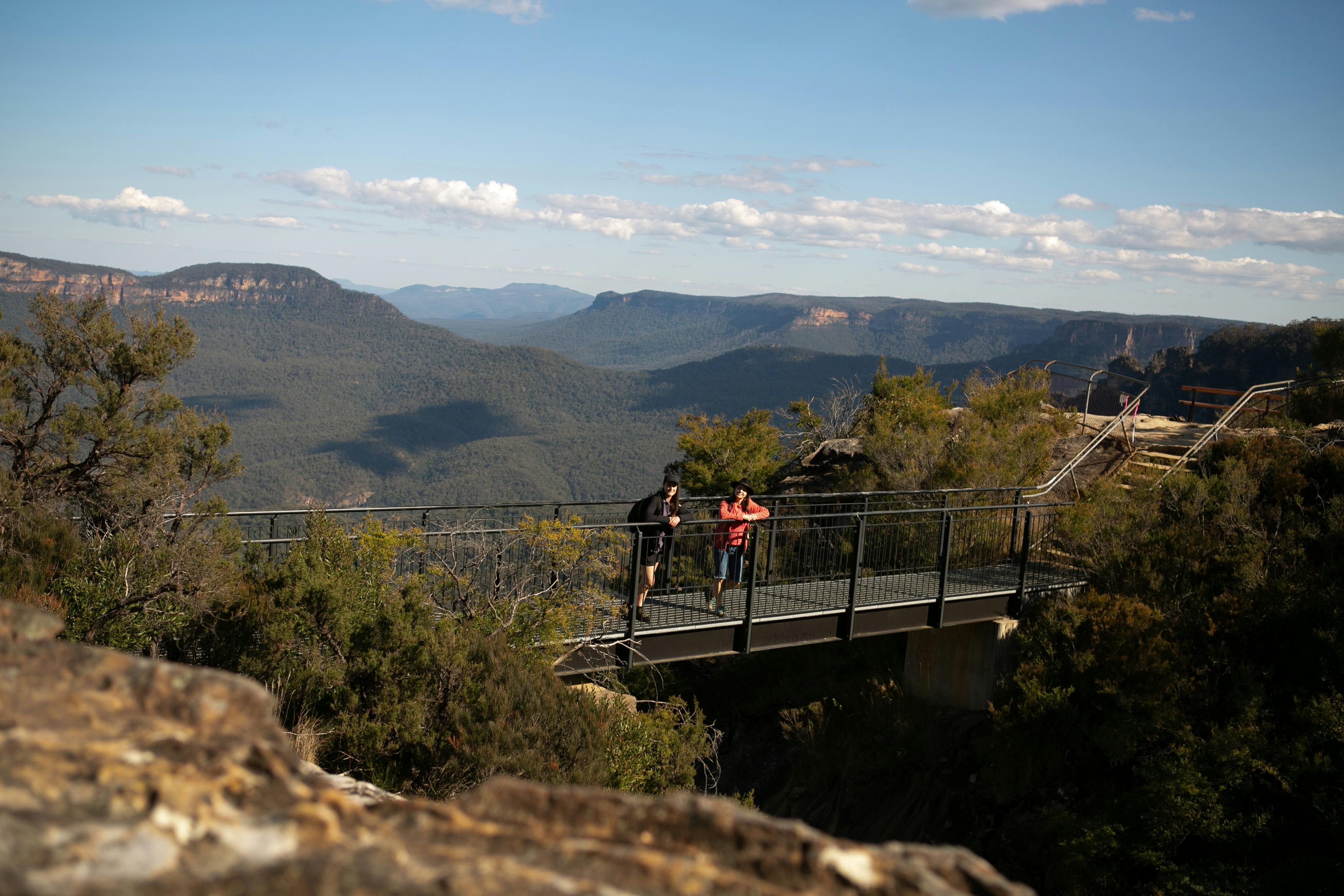 Walkers taking a break on Buttenshaw Bridge on the Grand Cliff Top Walk