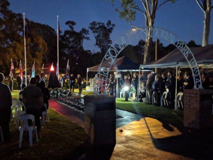 Image of a cenotaph and crowd of people at a dawn service