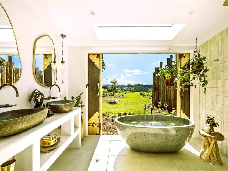 Luxurious bathroom with a sleek freestanding bathtub positioned to offer stunning views