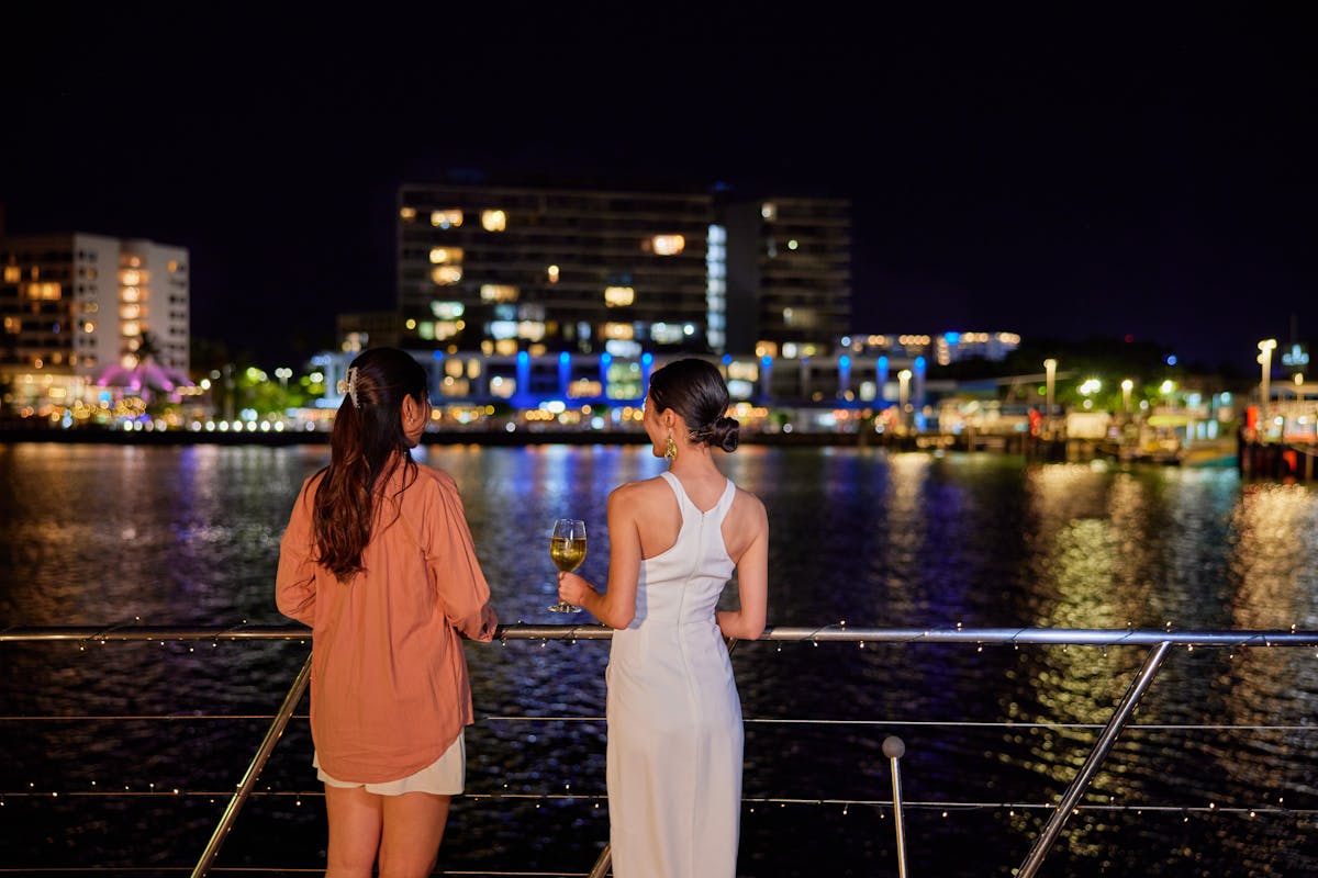 Ladies looking at city lights of Cairns