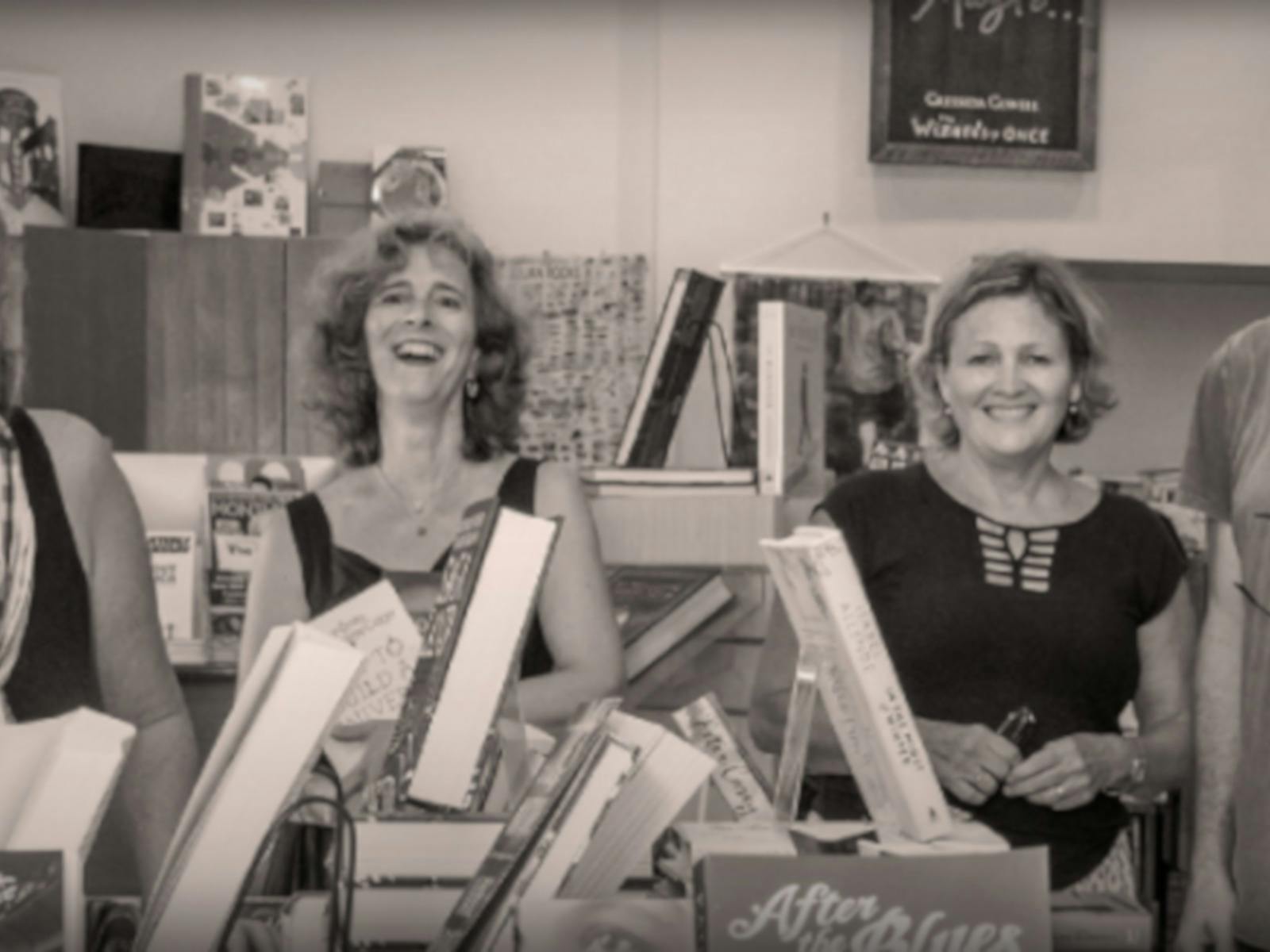 Happy Staff in the book store holding books