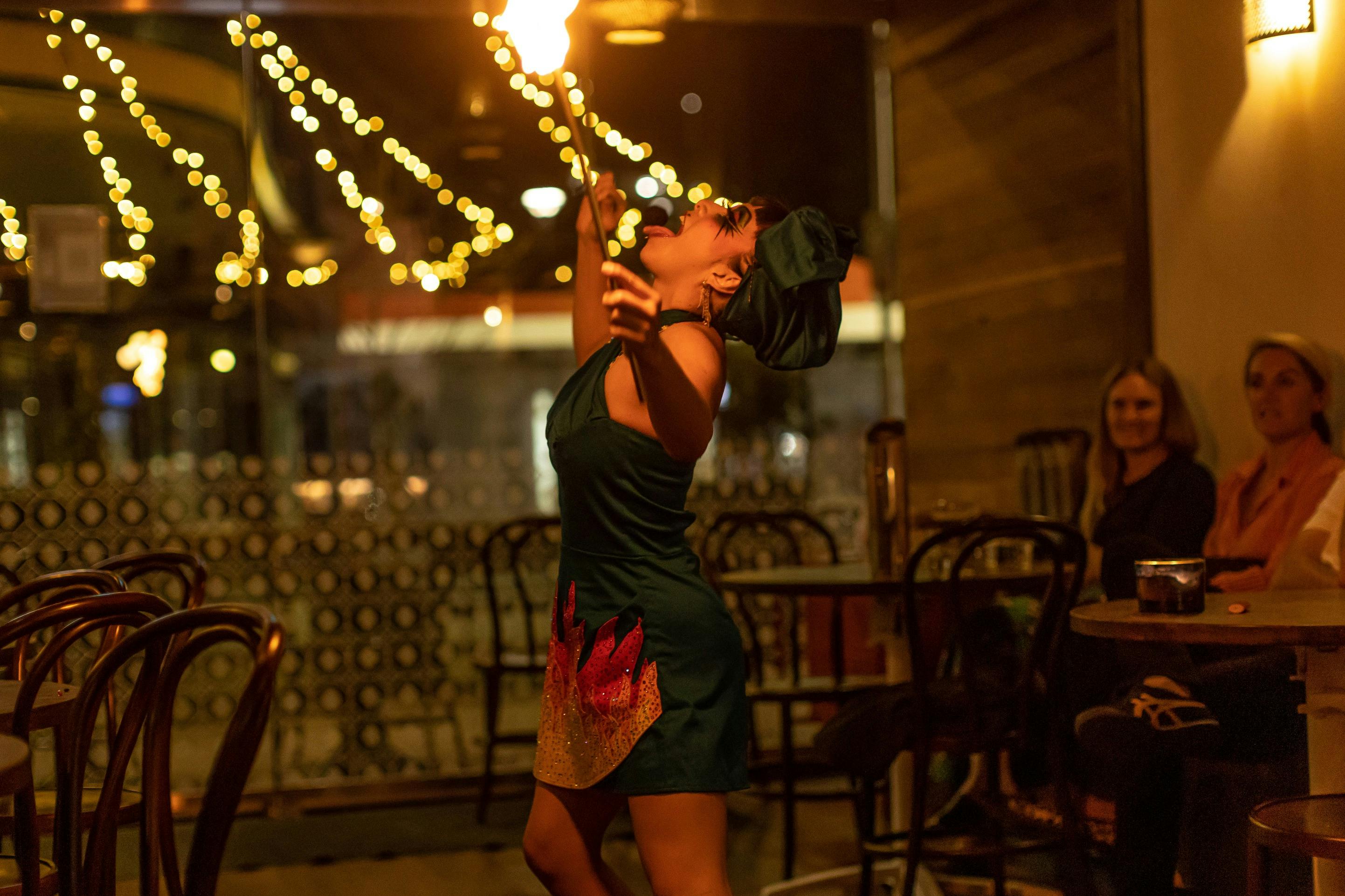 Burlesque performers breathing fire