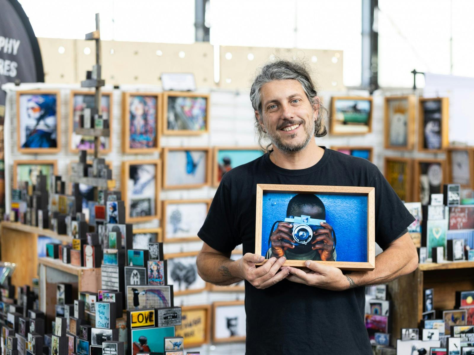 I Am Someone holding one of their photo blocks