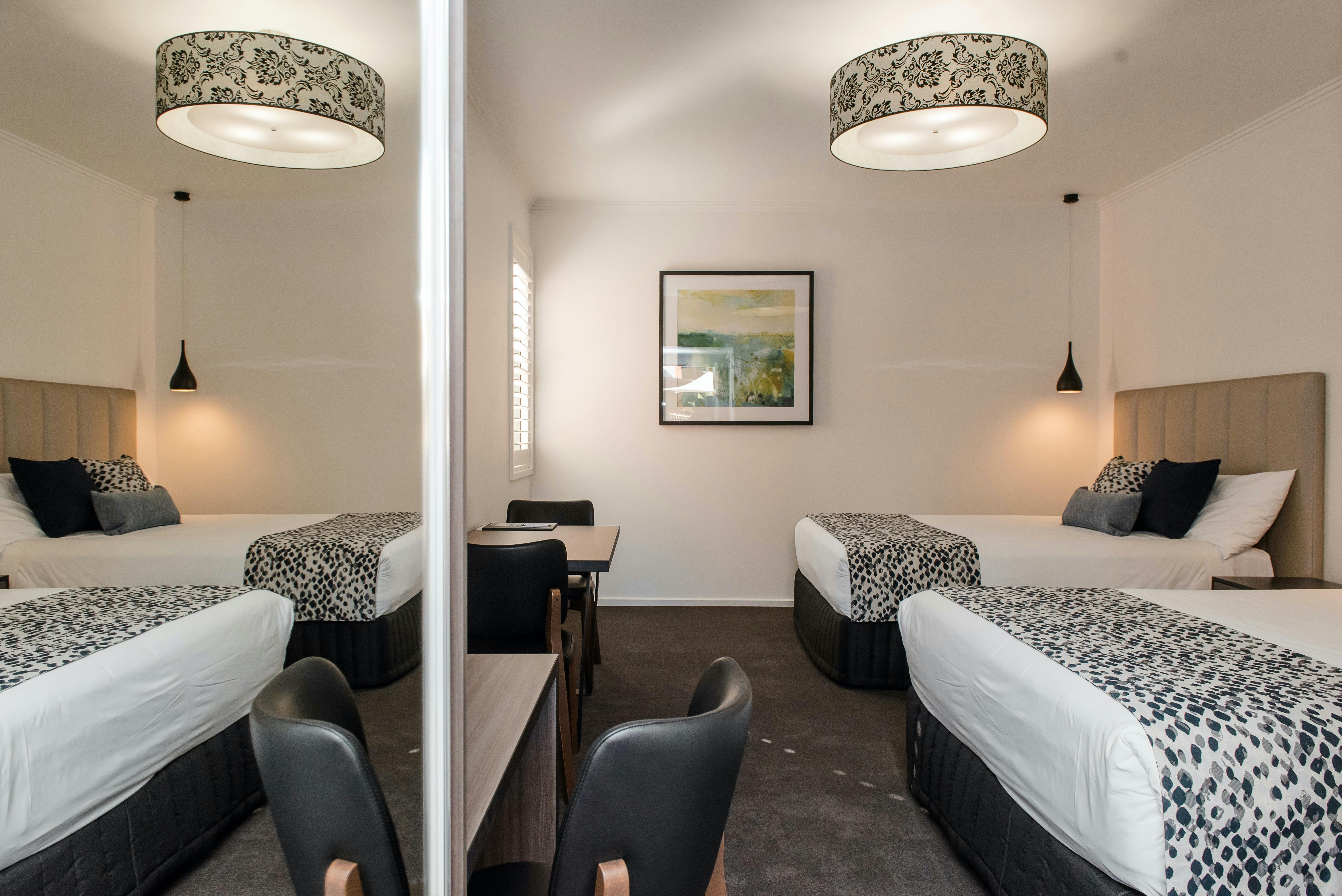 View of family suite with two double beds, wardrobe and desk area at The Gateway