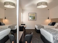 View of family suite with two double beds, wardrobe and desk area at The Gateway
