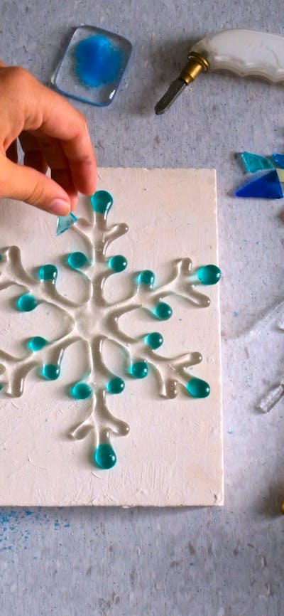 Hand arranging glass for kilnformed snow flake