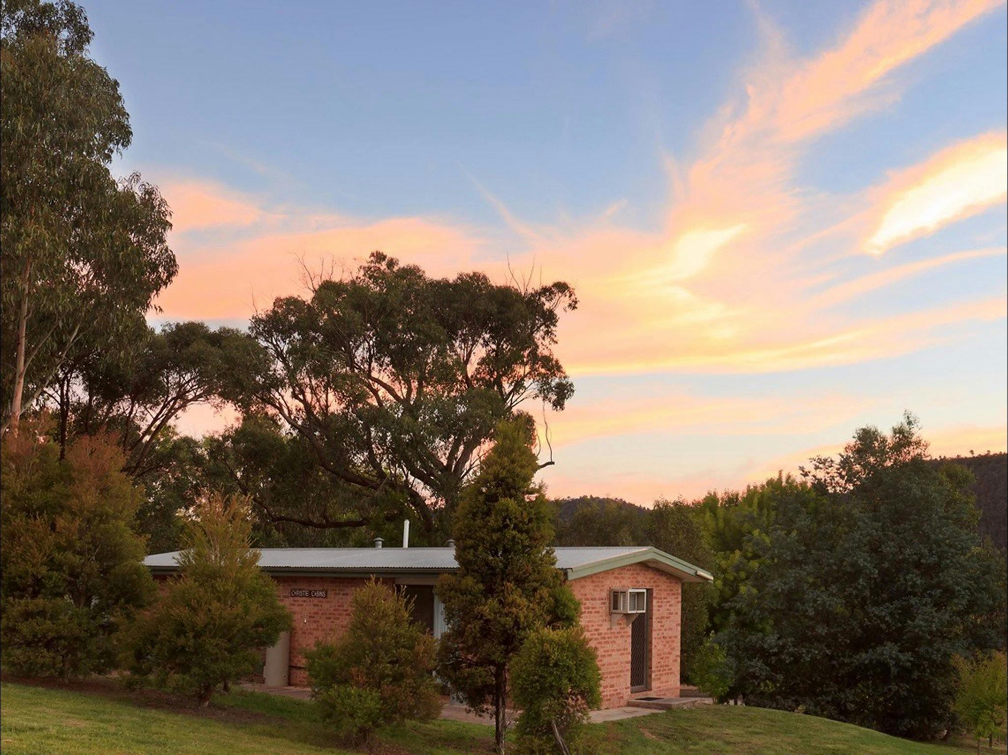 Brick cabin amongst trees