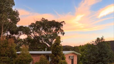 Brick cabin amongst trees