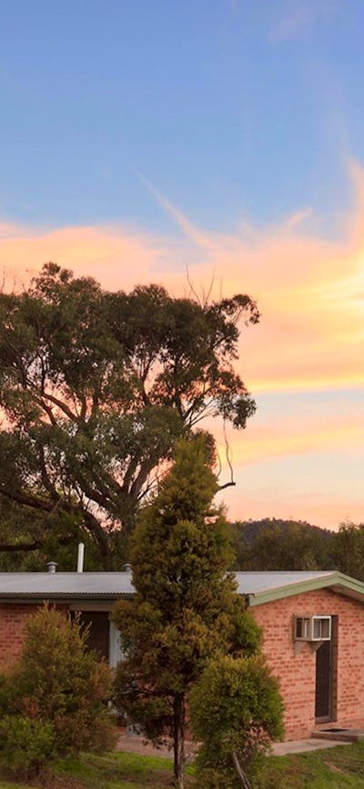 Brick cabin amongst trees