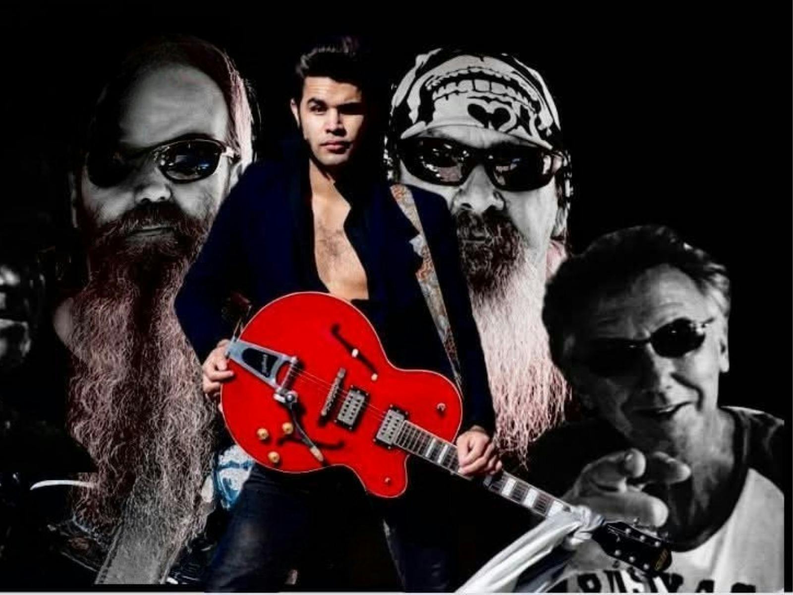 A man with a red guitar stands against the backdrop of faces with sunglasses