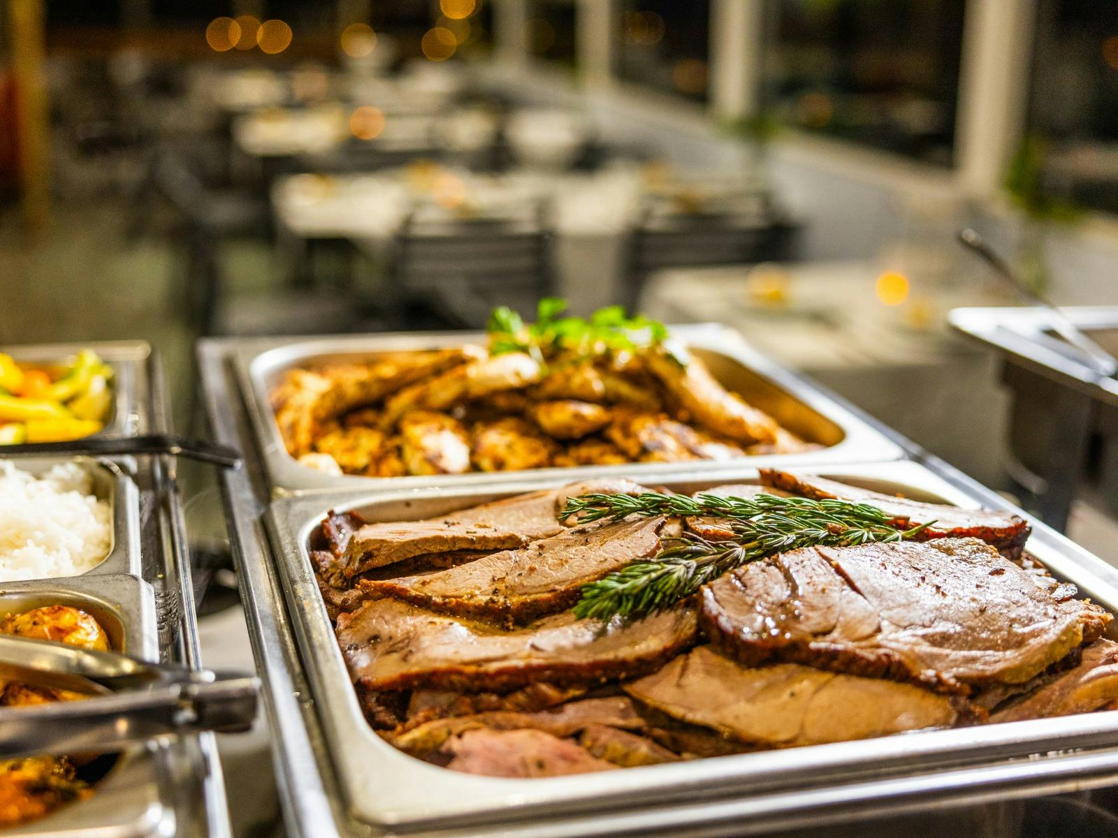 Roast lamb in a buffet dinner spread.