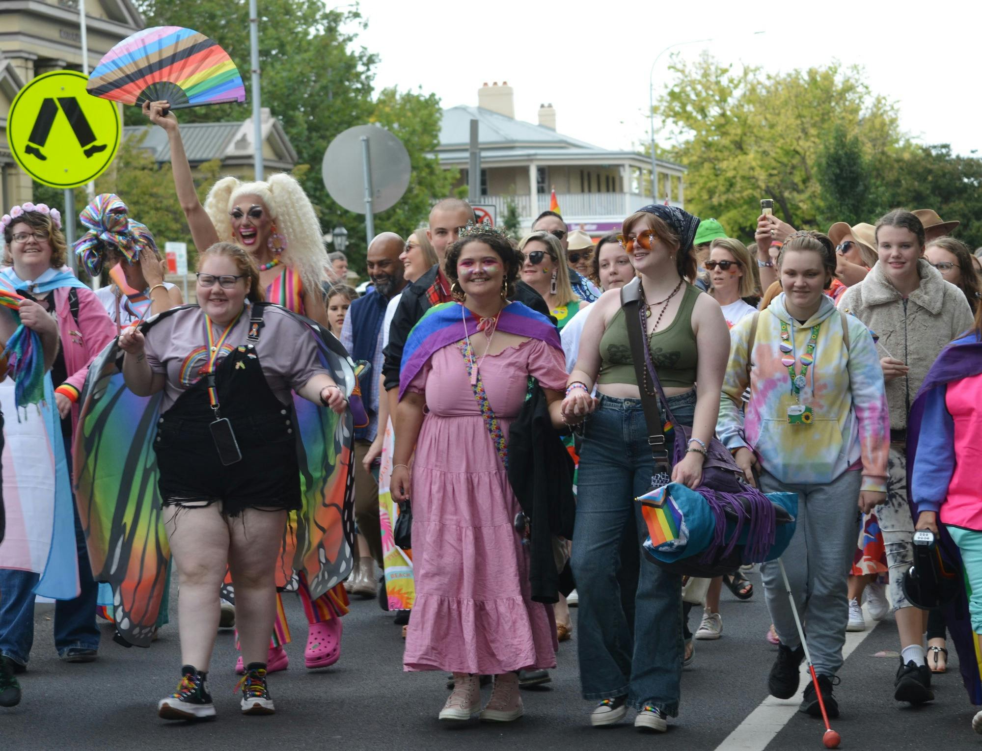 A colourful group of people participate in the rainbow walk.