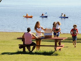 A family enjoying a picnic at Reflections Holiday Parks Copeton Waters