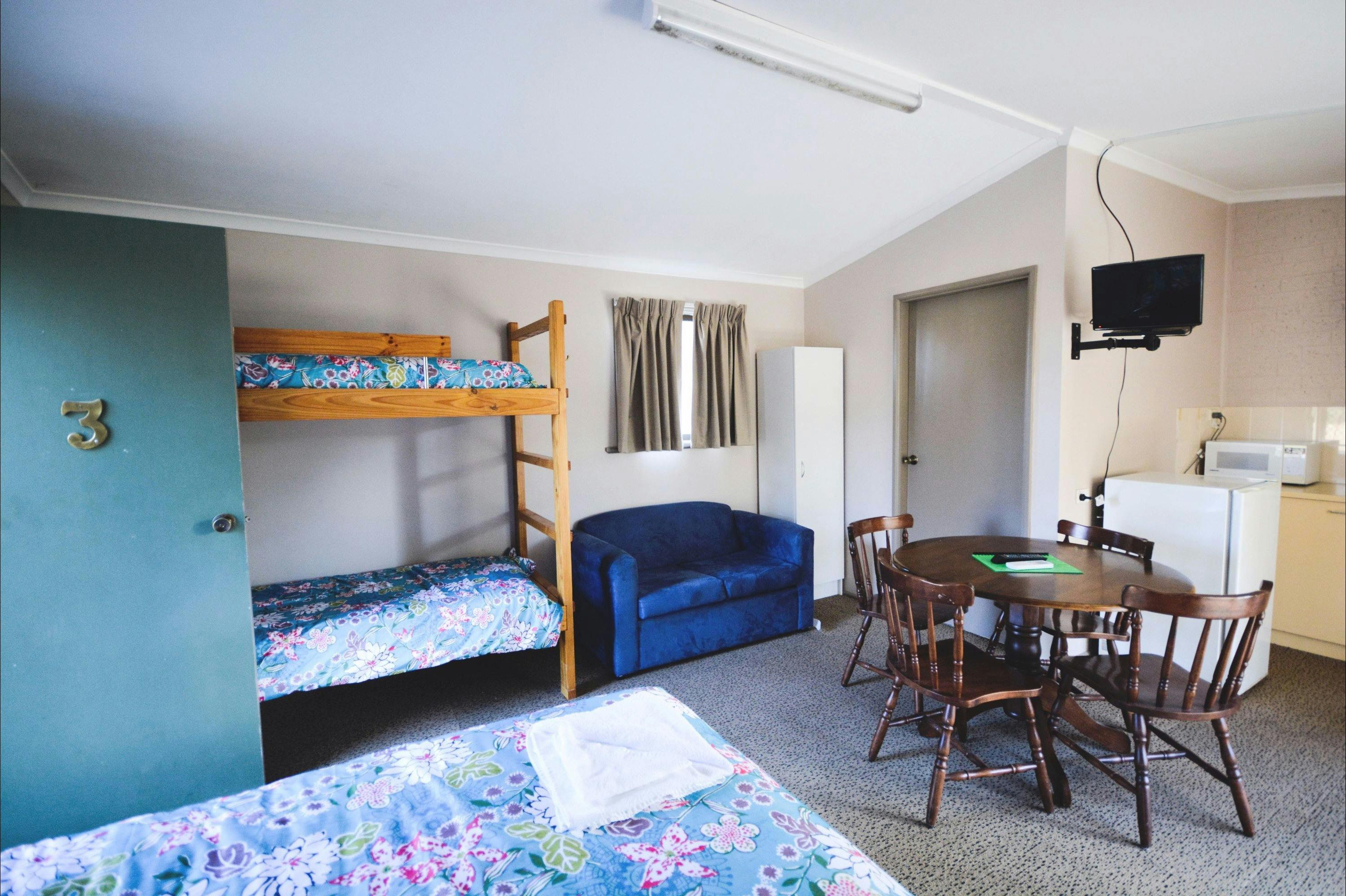 Christie Cabin interior with double bunks, double bed and kitchenette