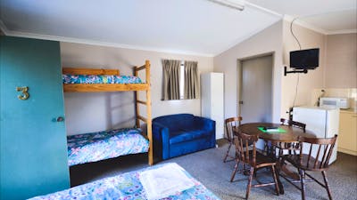 Christie Cabin interior with double bunks, double bed and kitchenette