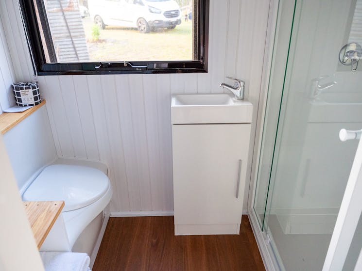 A comfortably-sized, sustainable bathroom that comes with hot water system