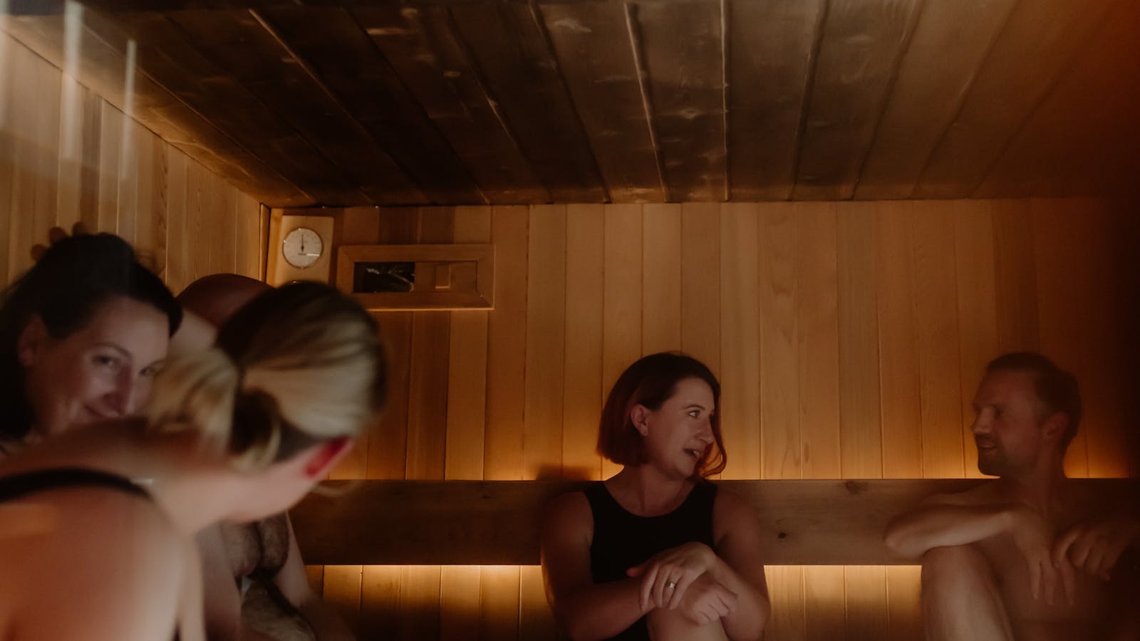 Guests share conversation, connection and relaxation during a communal sauna session.