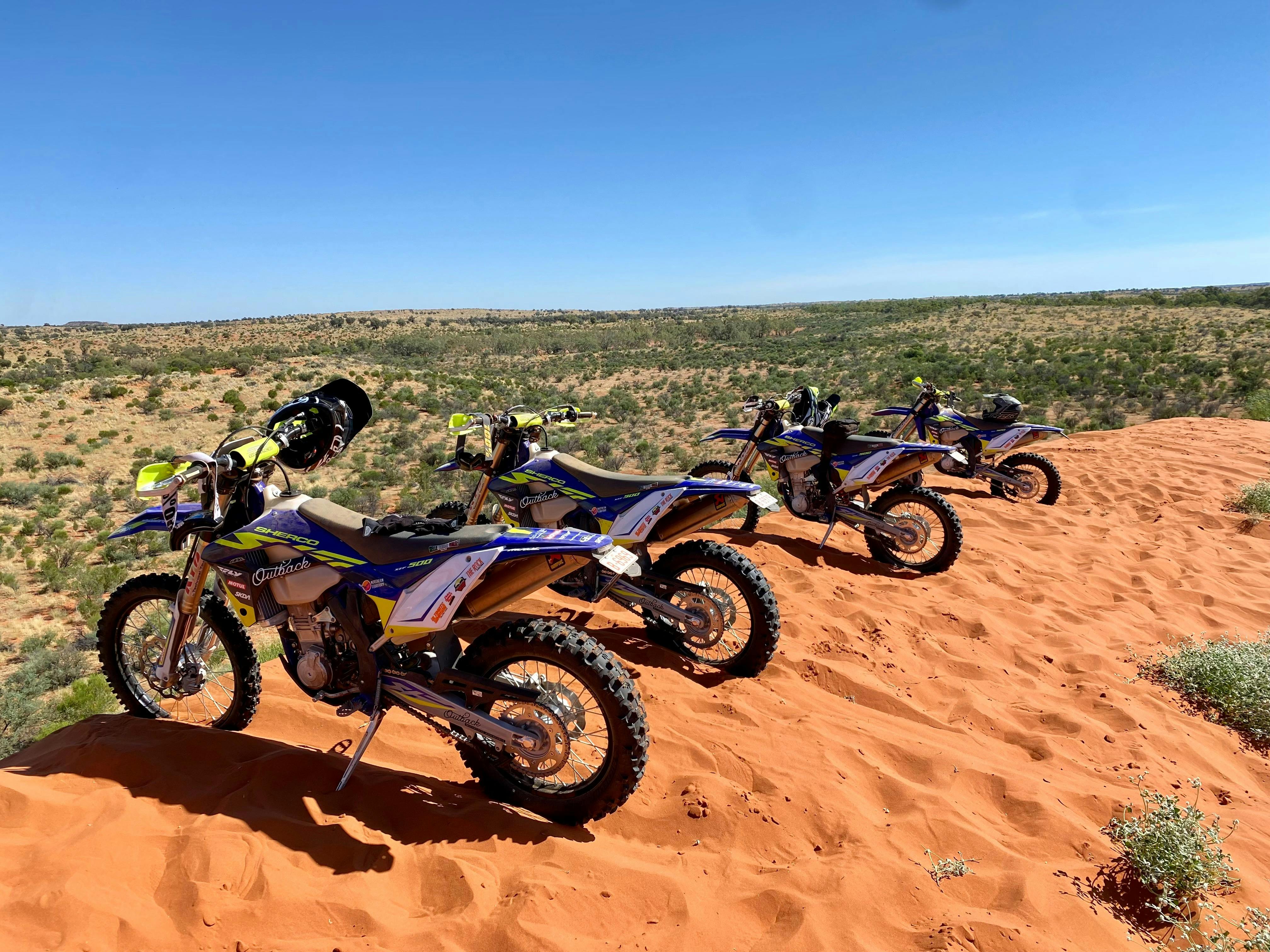 Bikes parked on top of a big sand dune