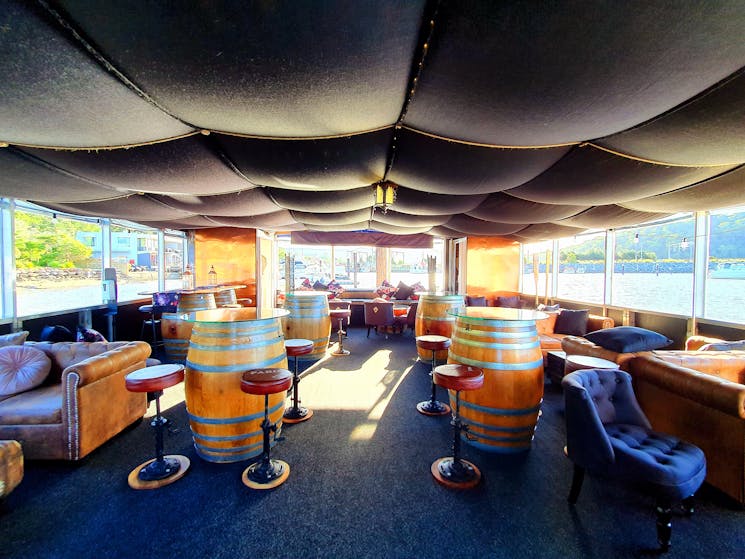 Inside The Floating Oyster room layout wine barrels and cosy lounges